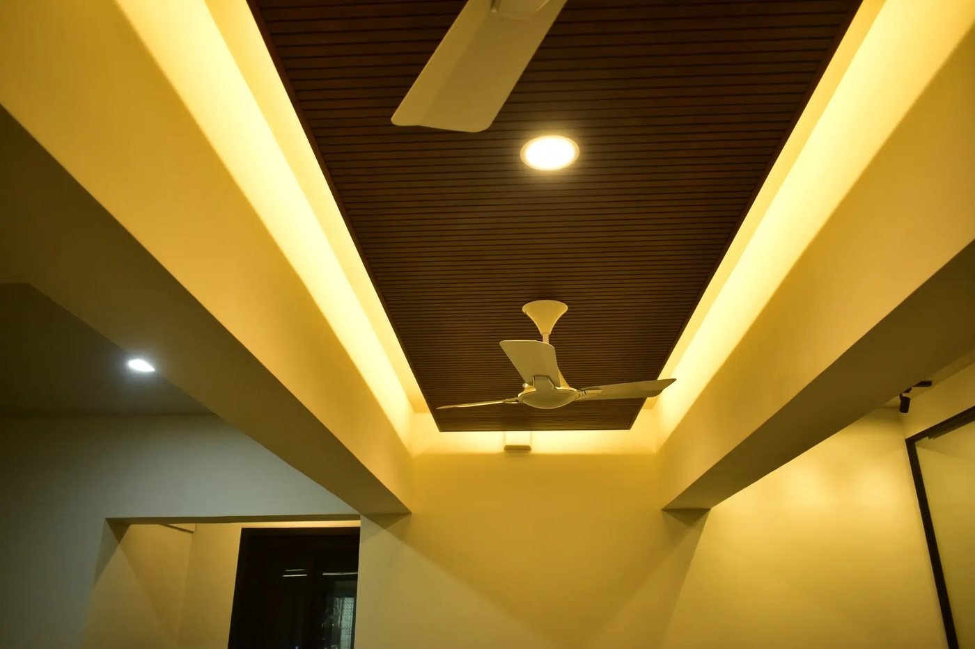 Wood-slat ceiling with cove lighting