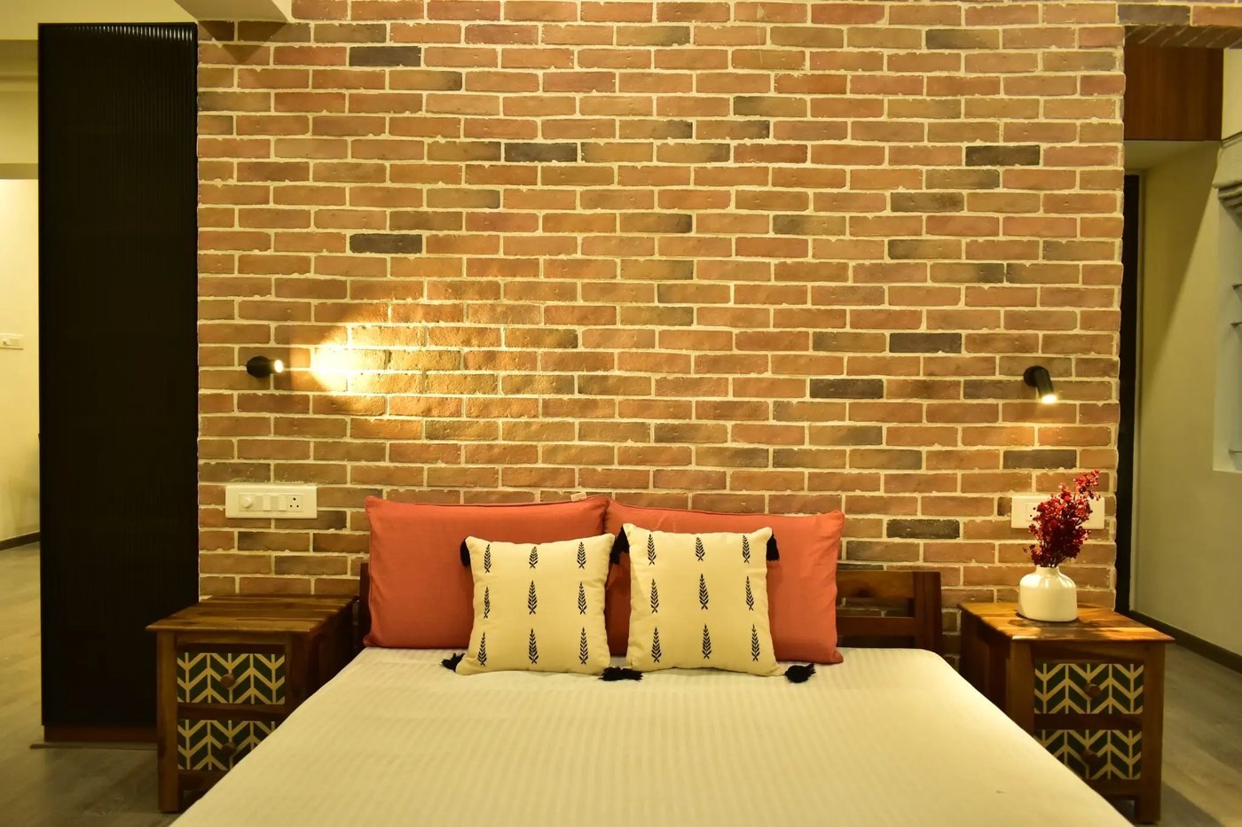 Bedroom with exposed brick headboard wall
