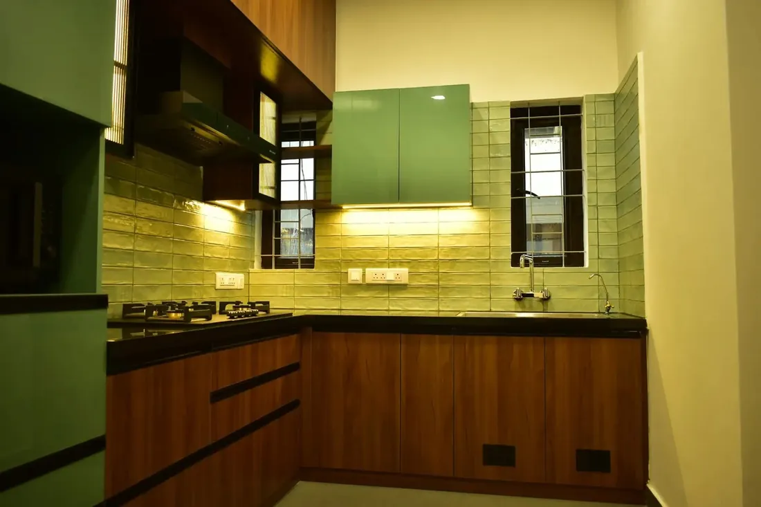Sage-green kitchen with wood-grain cabinets