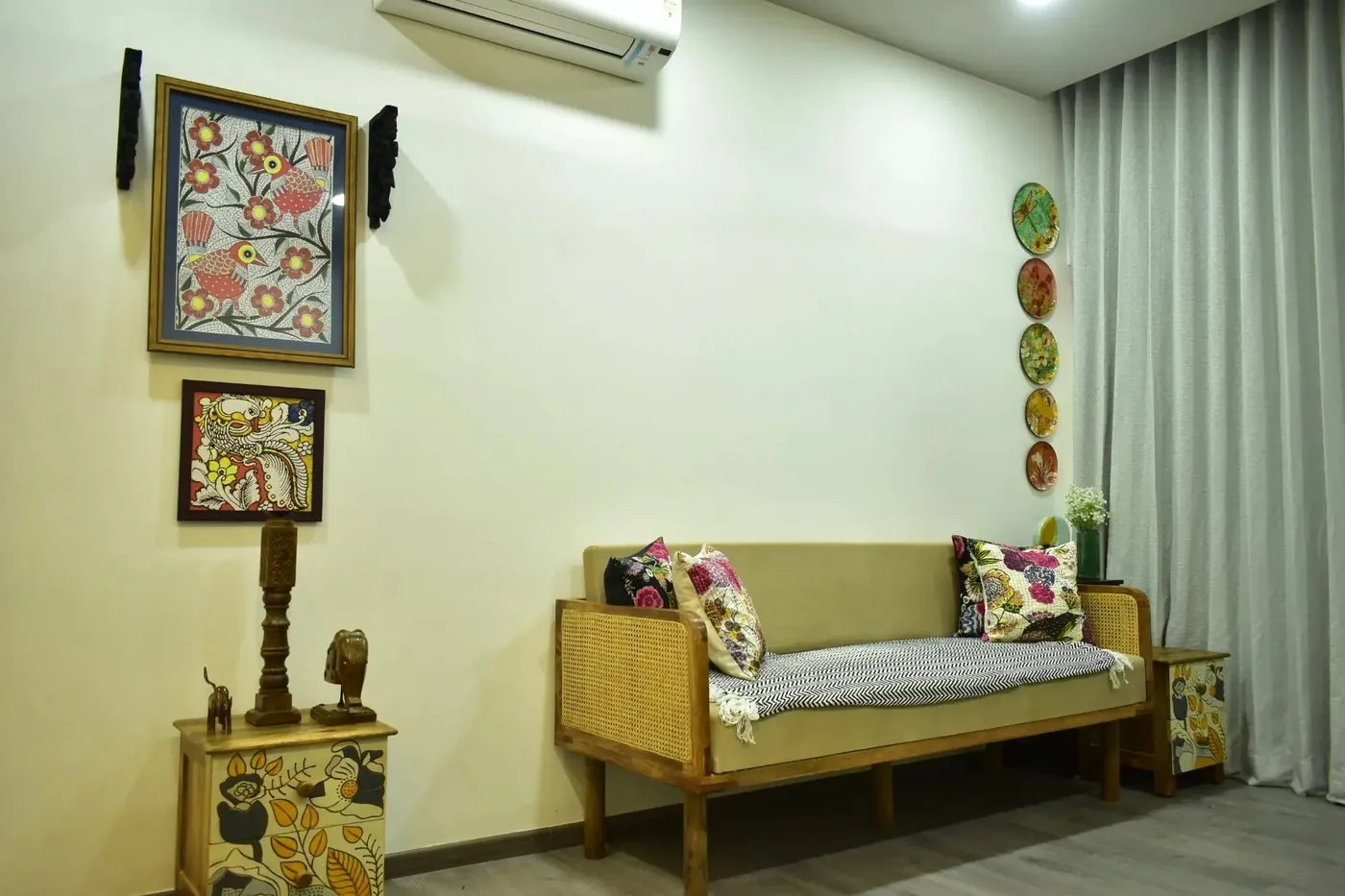 Cane sofa with folk-art paintings